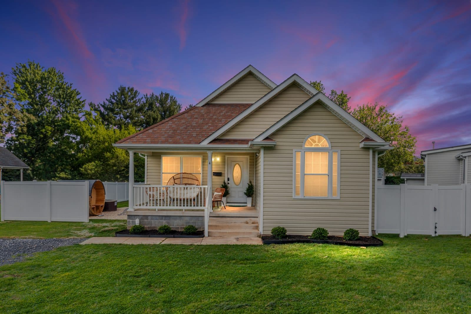 Twilight exterior of Heart of Luray showing the fenced yard and sauna